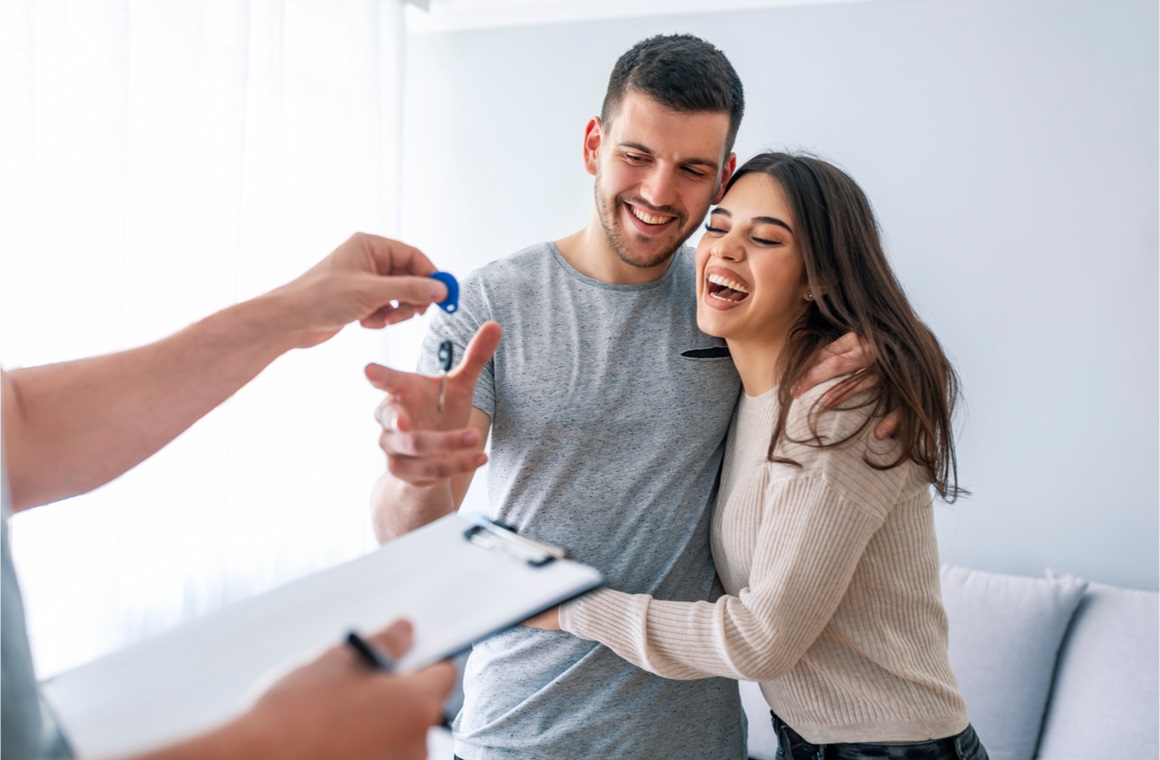 happy couple is taking keys