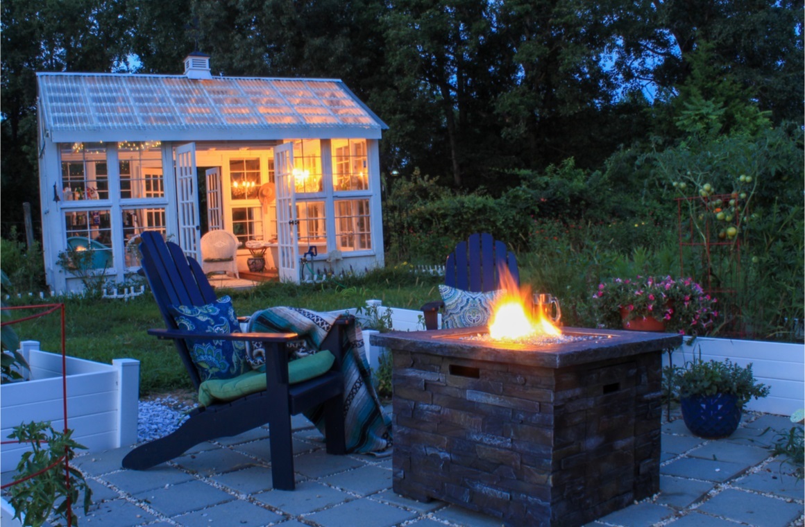 beautiful garden scene at dusk with firepit