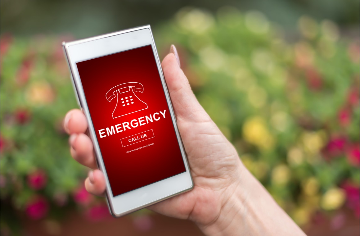 hand holding a smartphone with emergency concept