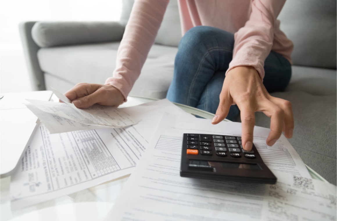 woman renter holding paper bills