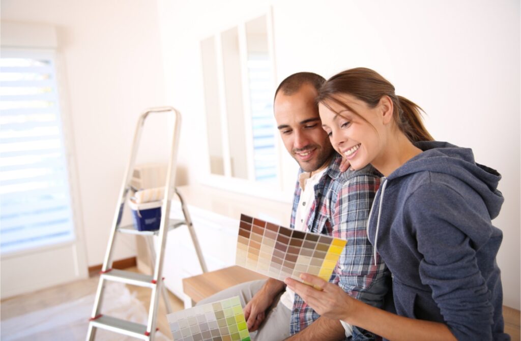 Happy couple choosing paint colors