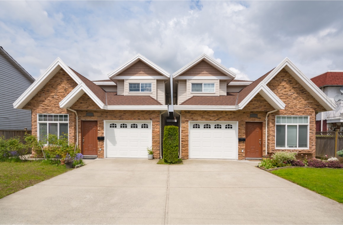 residential duplex house with concrete drive way