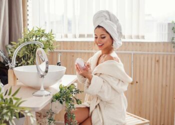 Beautiful young woman dressed in a bathrobe