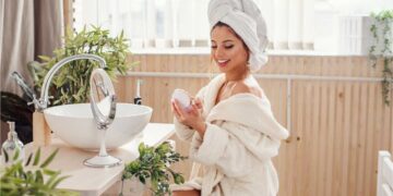 Beautiful young woman dressed in a bathrobe