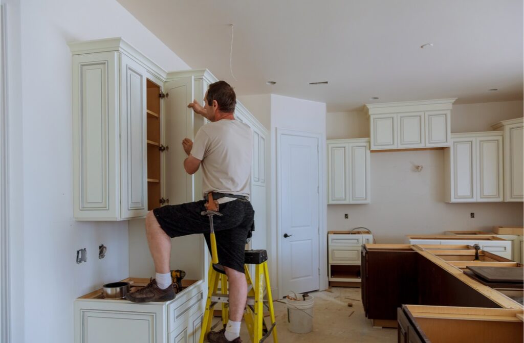 man installing cabinet doors