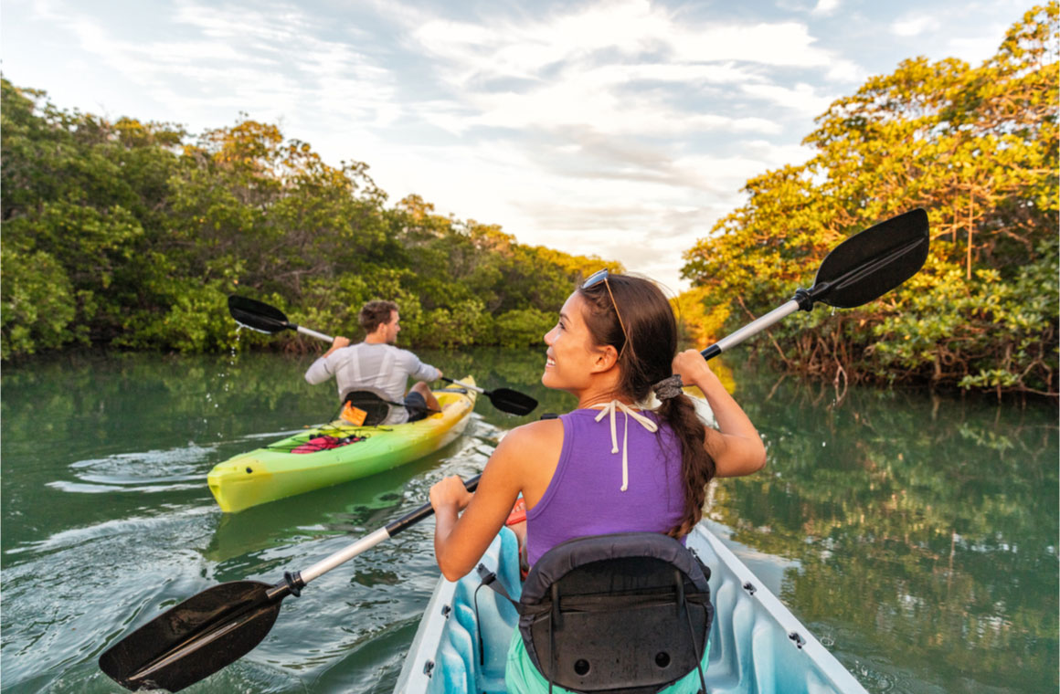 couple kayaking together in mangrove river