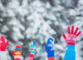 happy family with hands in the air winter season