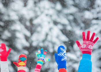 happy family with hands in the air winter season