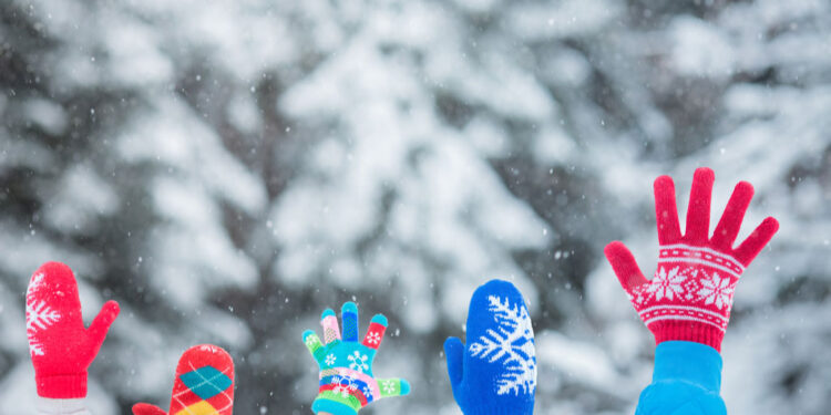 happy family with hands in the air winter season
