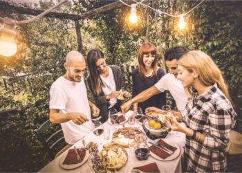 happy friends having fun eating local