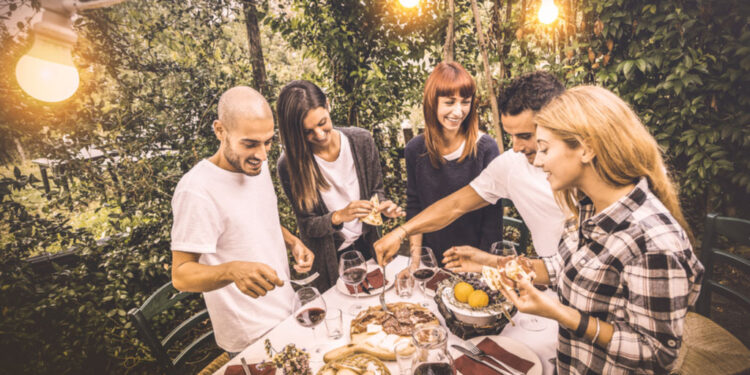 happy friends having fun eating local