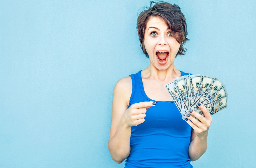 happy woman with money in hand