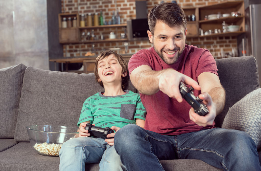 father and son playing video game