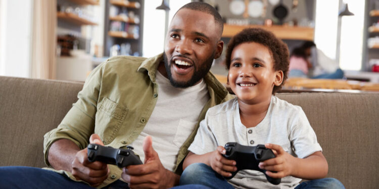 father son sitting on sofa lounge