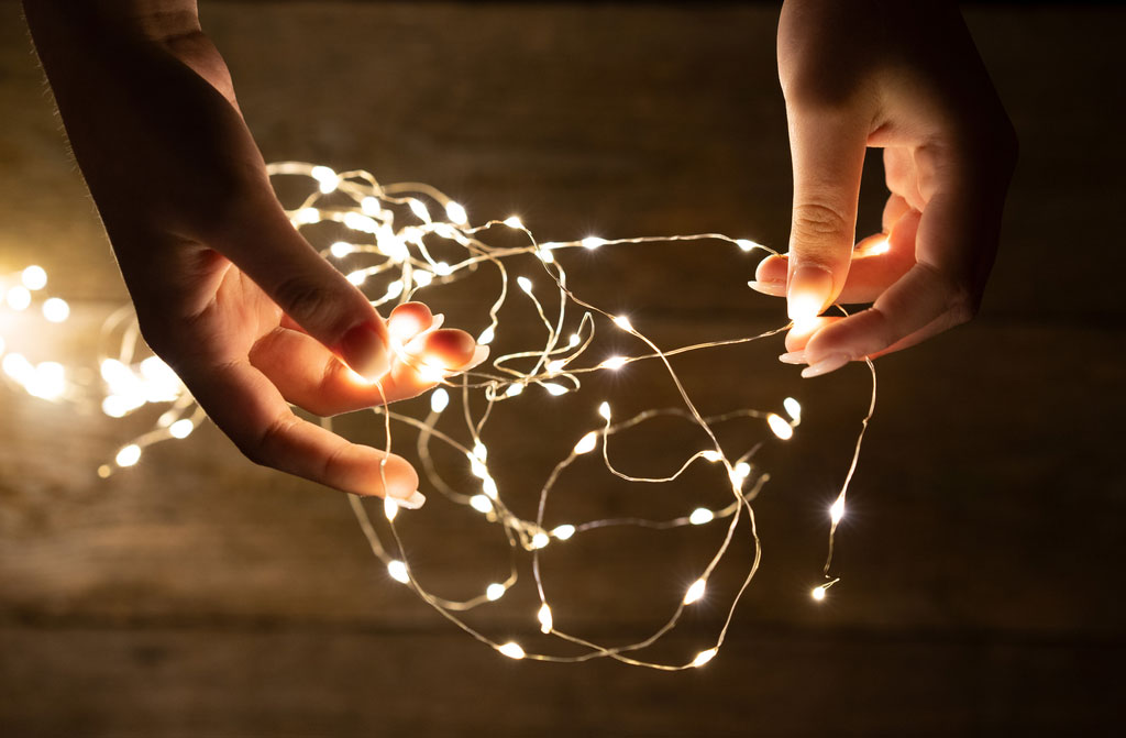 young woman hands holding lights