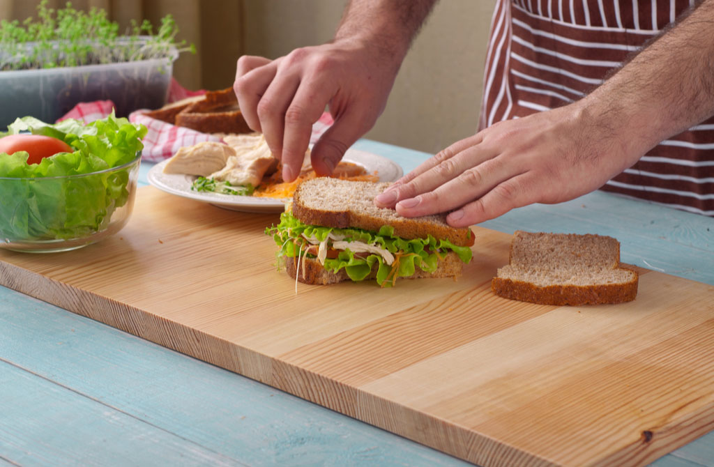 man cooking big sandwich chicken