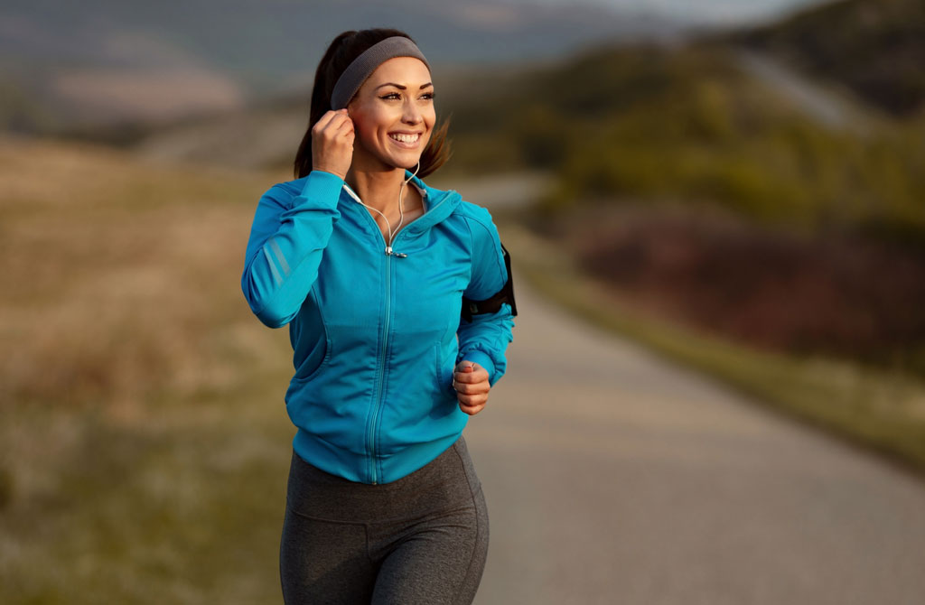 happy athletic woman listening music