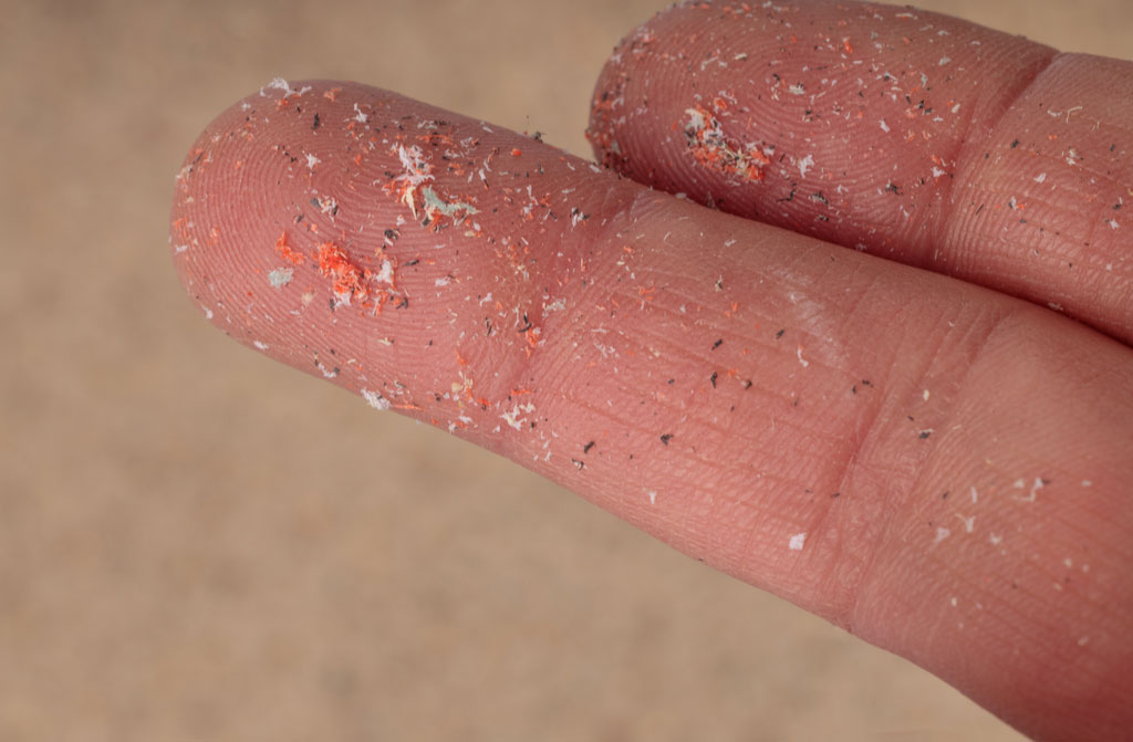 close up of microplastic on fingers