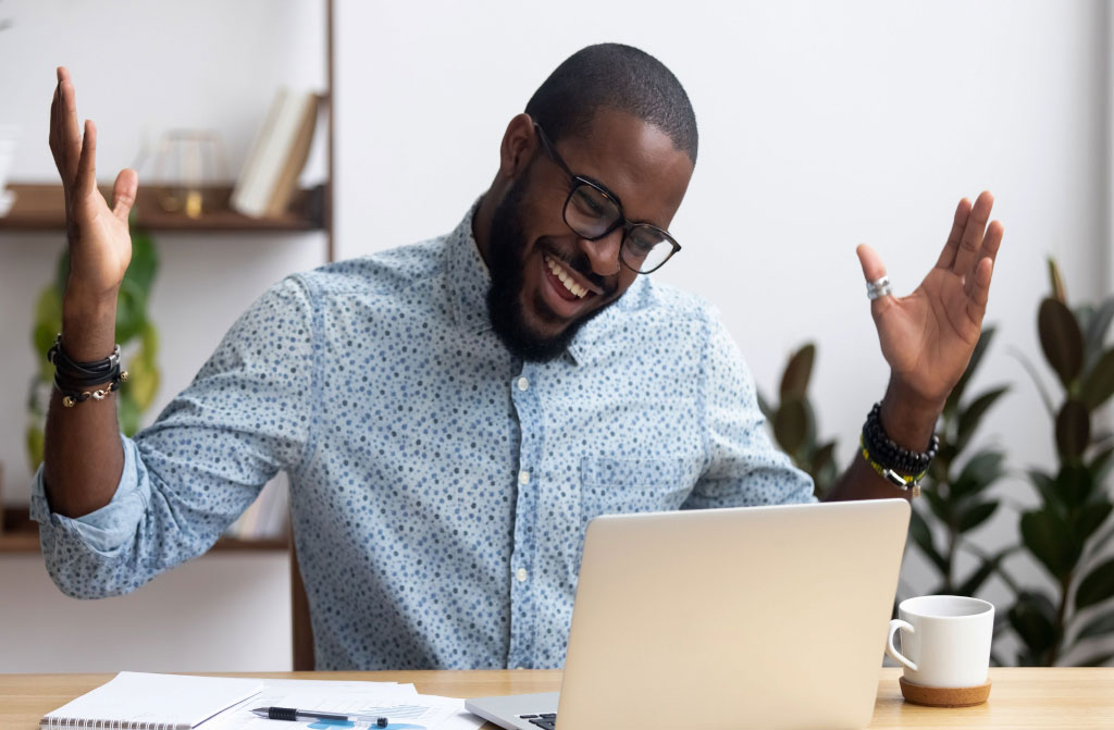 joyfull black businessman sitting desk