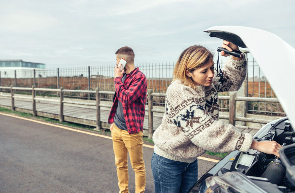 woman repairing broke down camper van