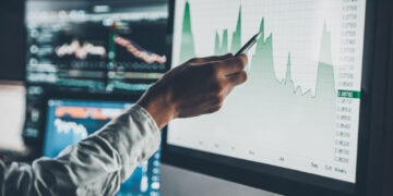 analyzing data close young businessman pointing