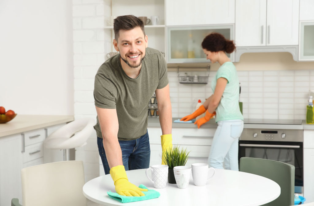 happy young couple cleaning