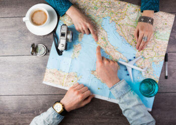 young couple planning honeymoon vacation trip