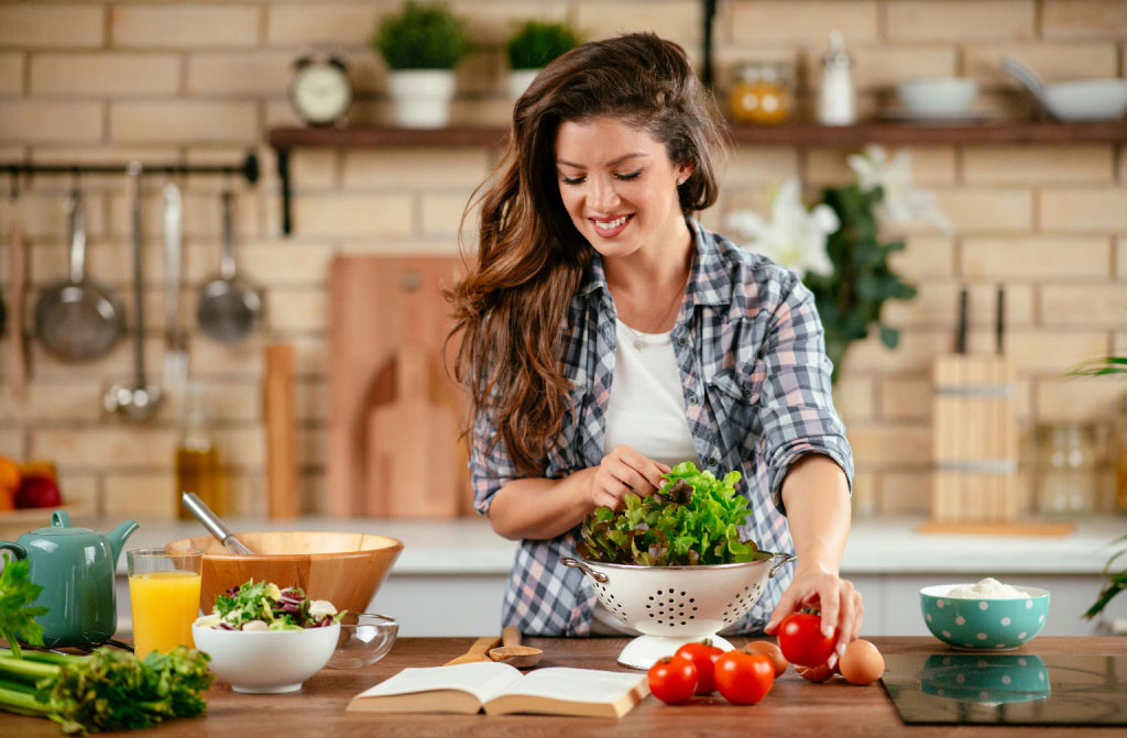 beautiful young woman preparing vegetables