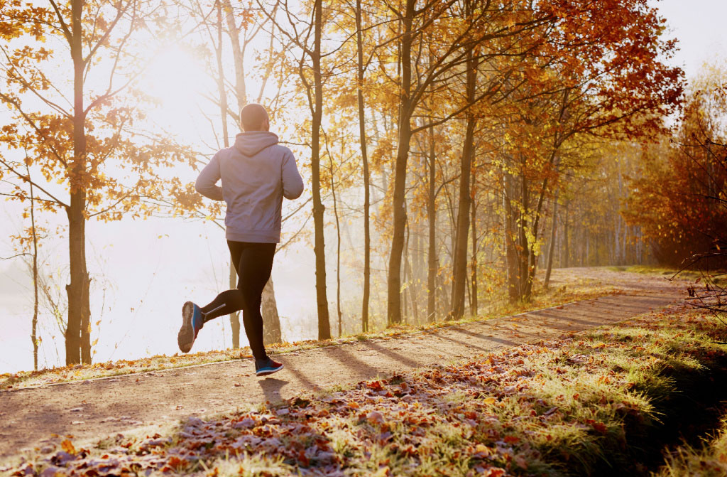 man running in park autumn