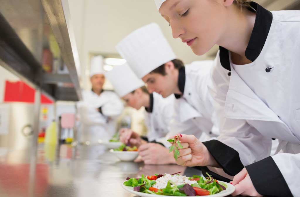 chef finishing her salad