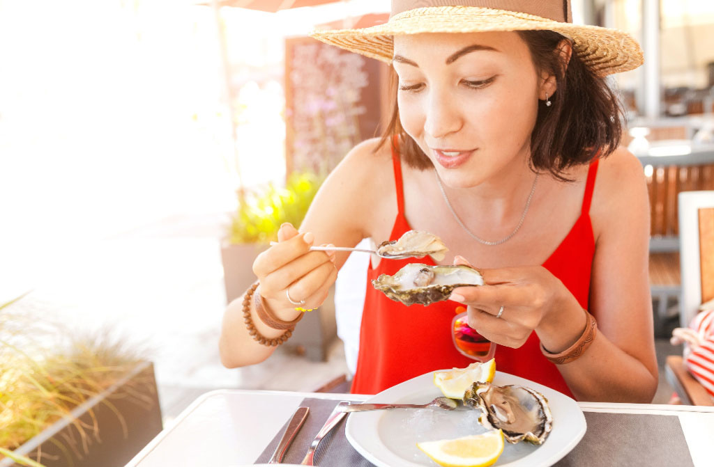 woman eating fresh marine food