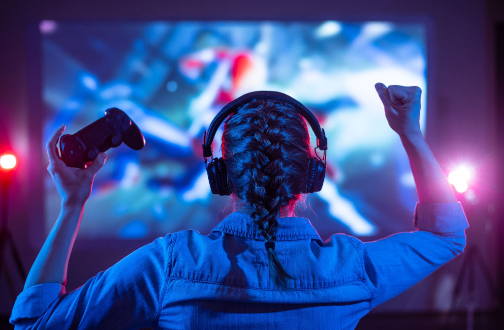 girl playing video game on tv