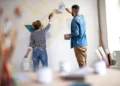 couple painting wall indoors