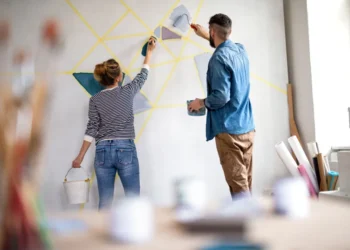 couple painting wall indoors