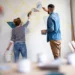 couple painting wall indoors