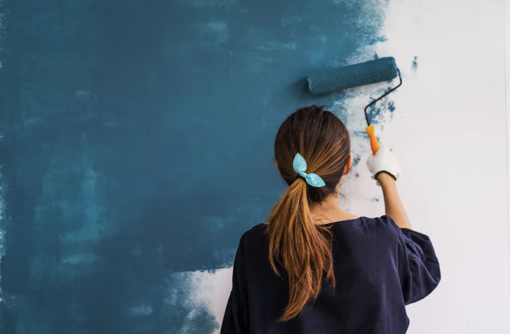 young asian happy woman painting