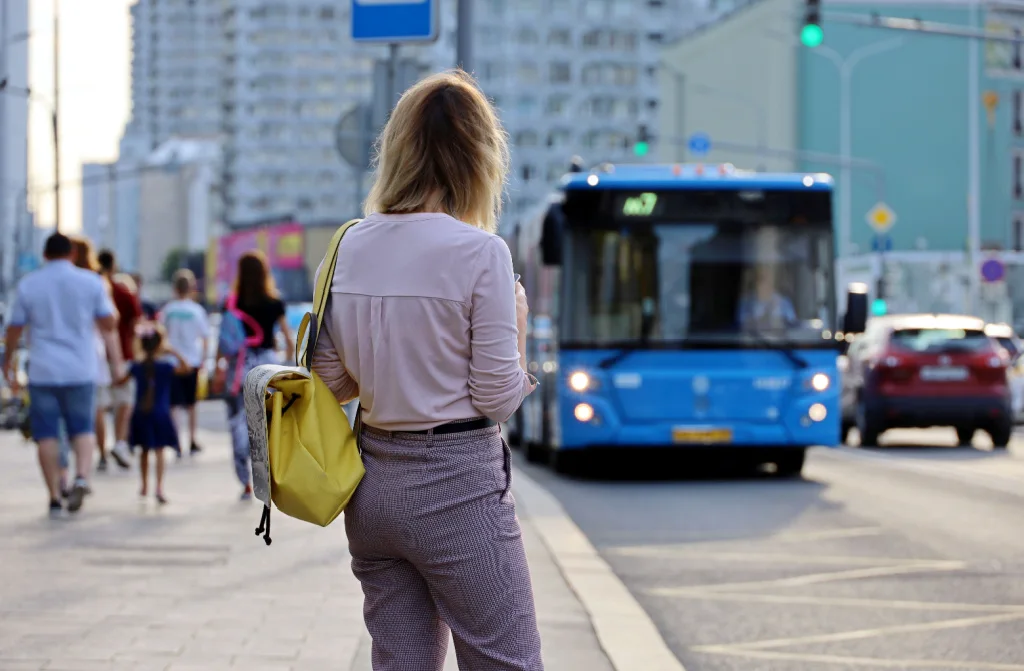 girl standing stop waiting for bus