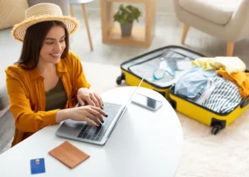 happy young woman planning vacation travel