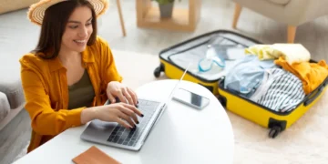 happy young woman planning vacation travel