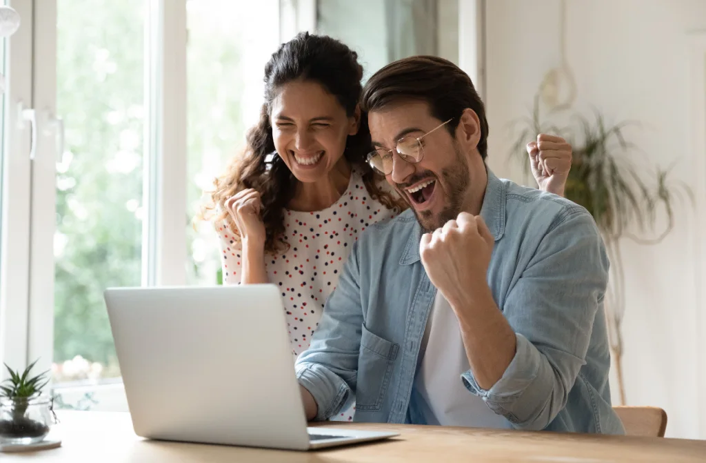 overjoyed millenial couple